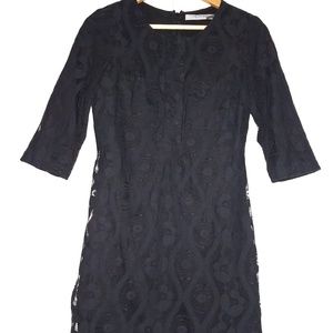 Dress with over lace layer with unique pattern.